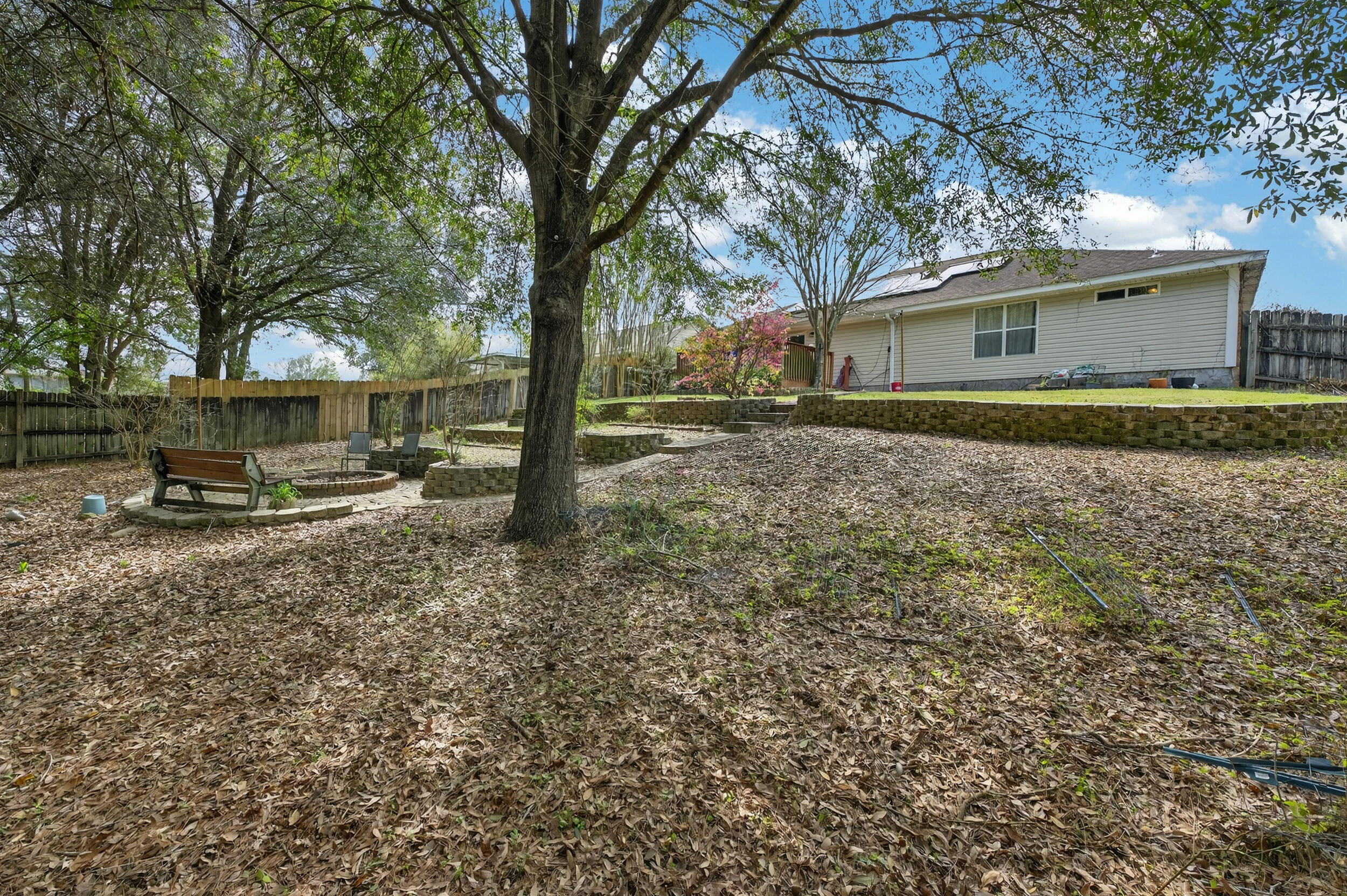 4717 Whitewater Lane Crestview, FL 32539 - Photo 52 of 55 a backyard of a house with outdoor seating