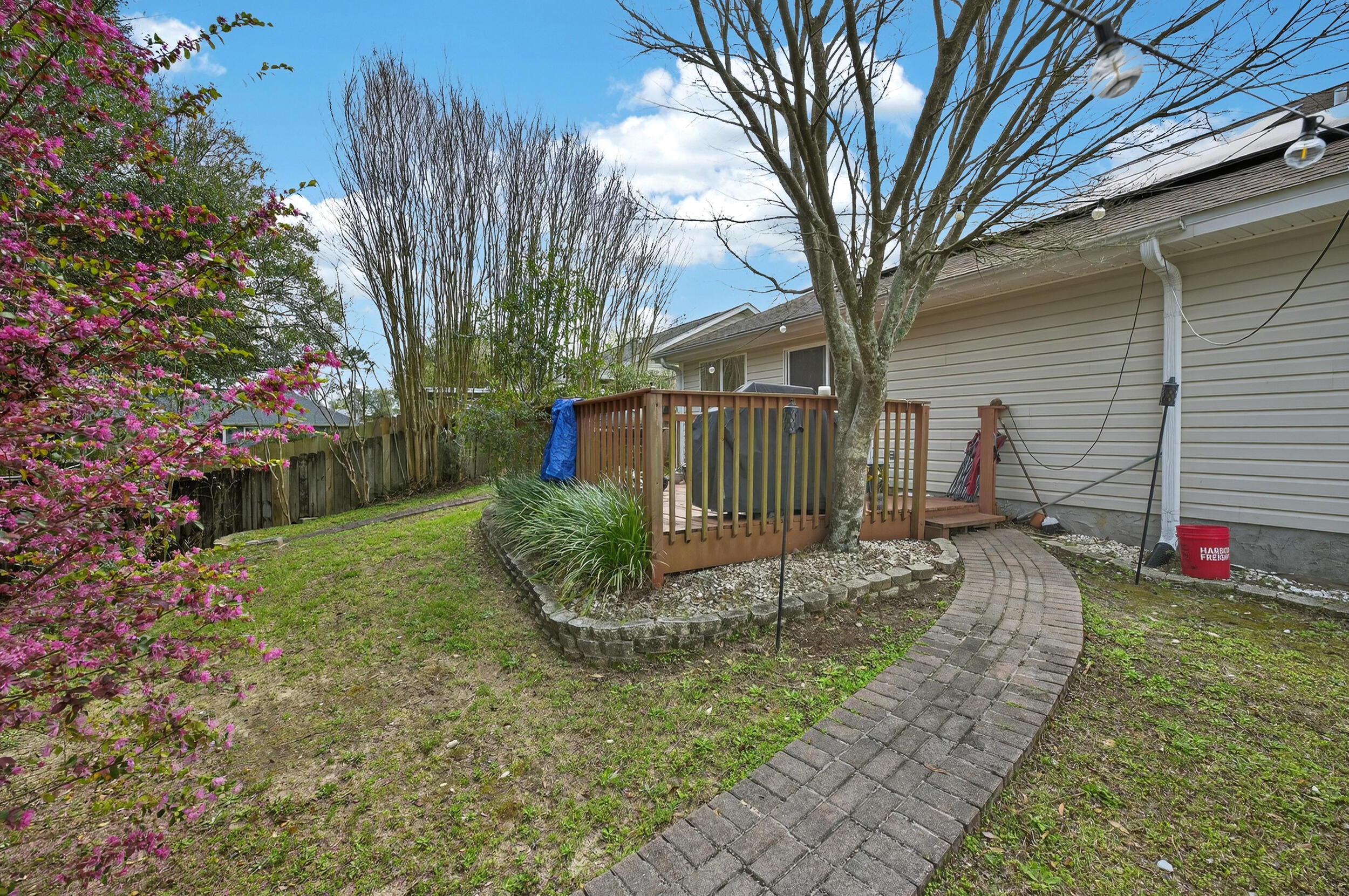 4717 Whitewater Lane Crestview, FL 32539 - Photo 55 of 55 a view of a small yard in front of a house with wooden fence
