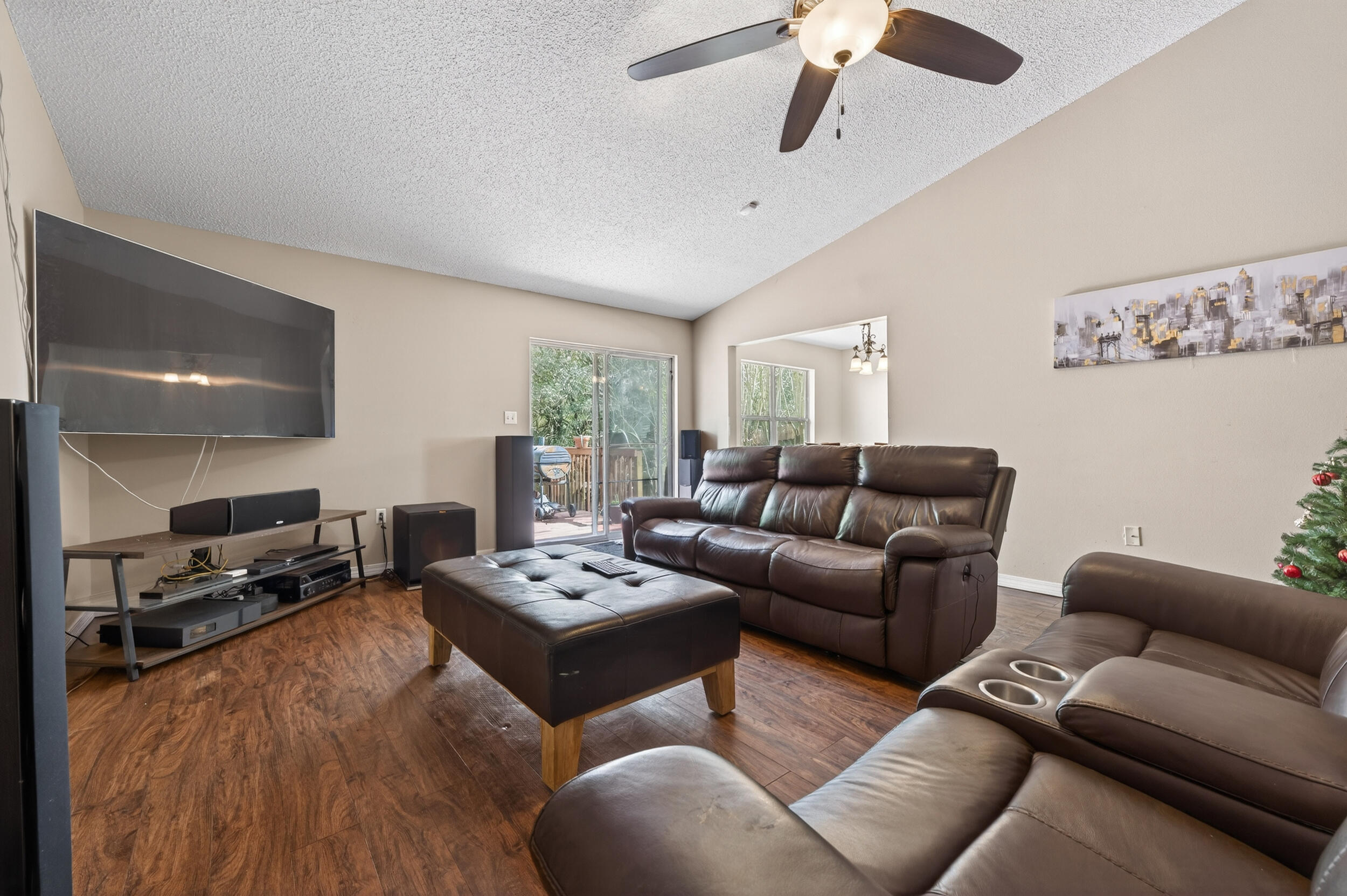 4717 Whitewater Lane Crestview, FL 32539 - Photo 9 of 55 a living room with furniture a ceiling fan and a wooden floor