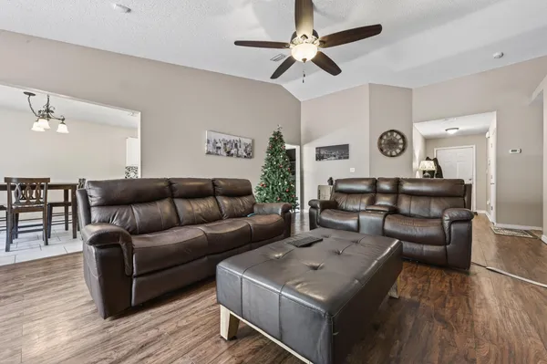 a living room with furniture and wooden floor