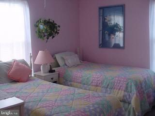 8747 New Hope Road Willards, MD 21874 - Photo 7 of 11 a bedroom with a bed and a potted plant