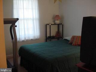 8747 New Hope Road Willards, MD 21874 - Photo 8 of 11 a bed sitting in a bedroom next to a window