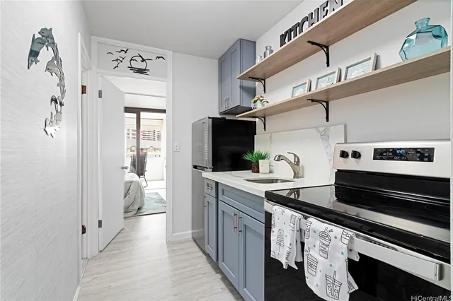 a kitchen with stainless steel appliances a stove and cabinets