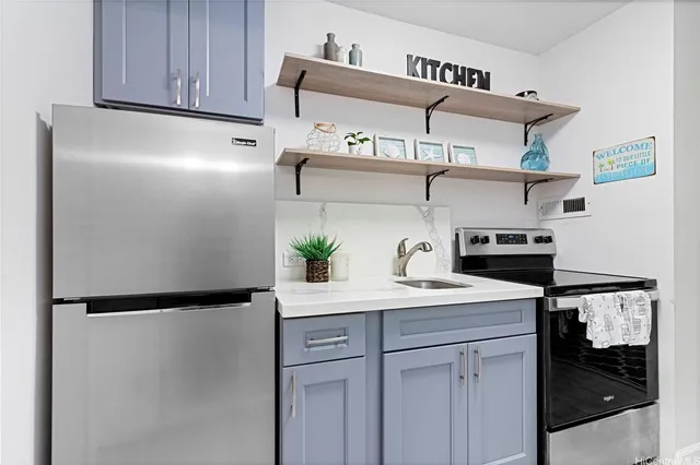 a kitchen with stainless steel appliances granite countertop a refrigerator and a sink