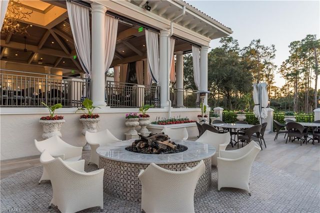 a living room with patio furniture and a fountain