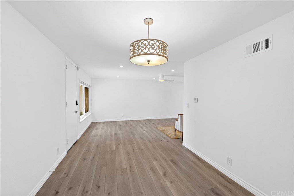 520 Cliff Drive, Unit 303 Laguna Beach, CA 92651 - Photo 11 of 46 a view of a hallway with wooden floor