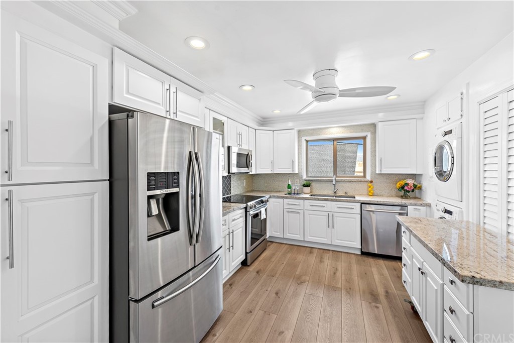 520 Cliff Drive, Unit 303 Laguna Beach, CA 92651 - Photo 12 of 46 a kitchen with stainless steel appliances a refrigerator sink and microwave