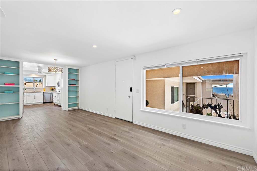520 Cliff Drive, Unit 303 Laguna Beach, CA 92651 - Photo 17 of 46 a view of an empty room with a window and wooden floor