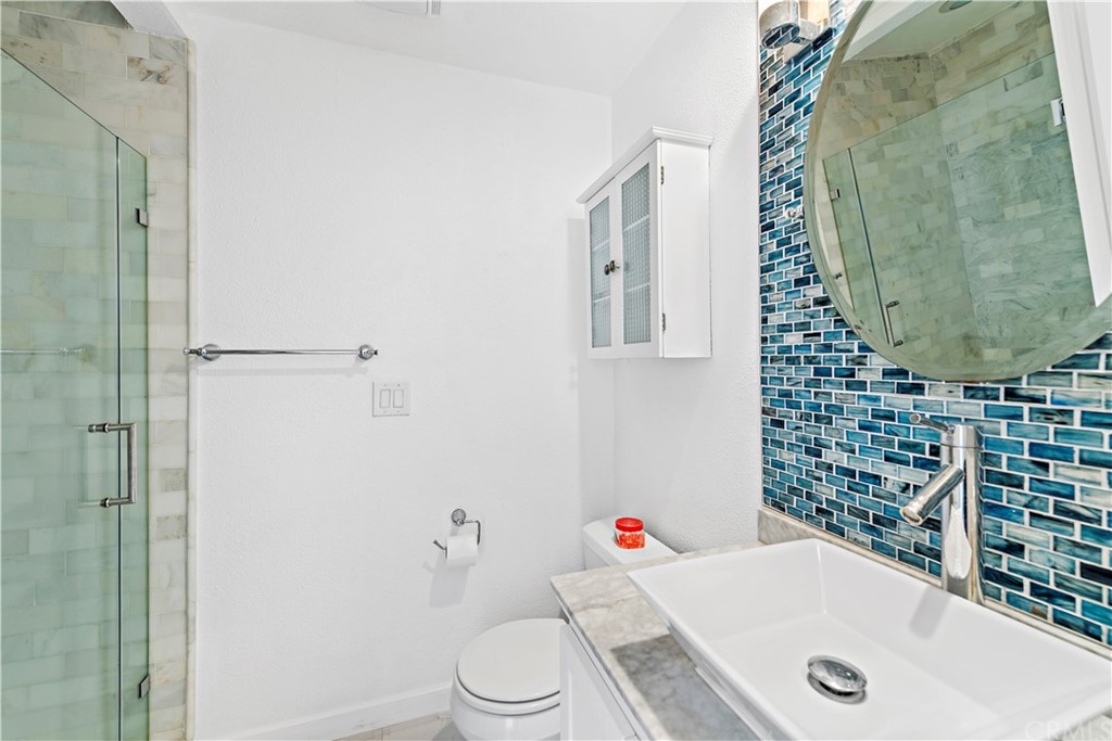 520 Cliff Drive, Unit 303 Laguna Beach, CA 92651 - Photo 18 of 46 a bathroom with a sink and toilet