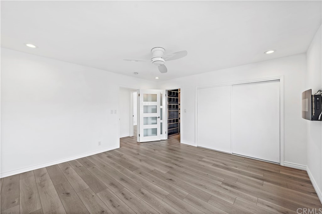 520 Cliff Drive, Unit 303 Laguna Beach, CA 92651 - Photo 20 of 46 a view of an empty room with wooden floor closet and windows
