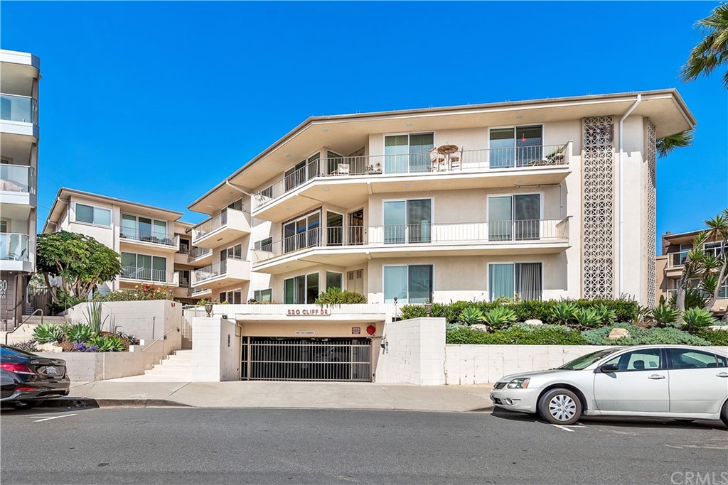 520 Cliff Drive, Unit 303 Laguna Beach, CA 92651 - Photo 2 of 46 a car parked in front of a house