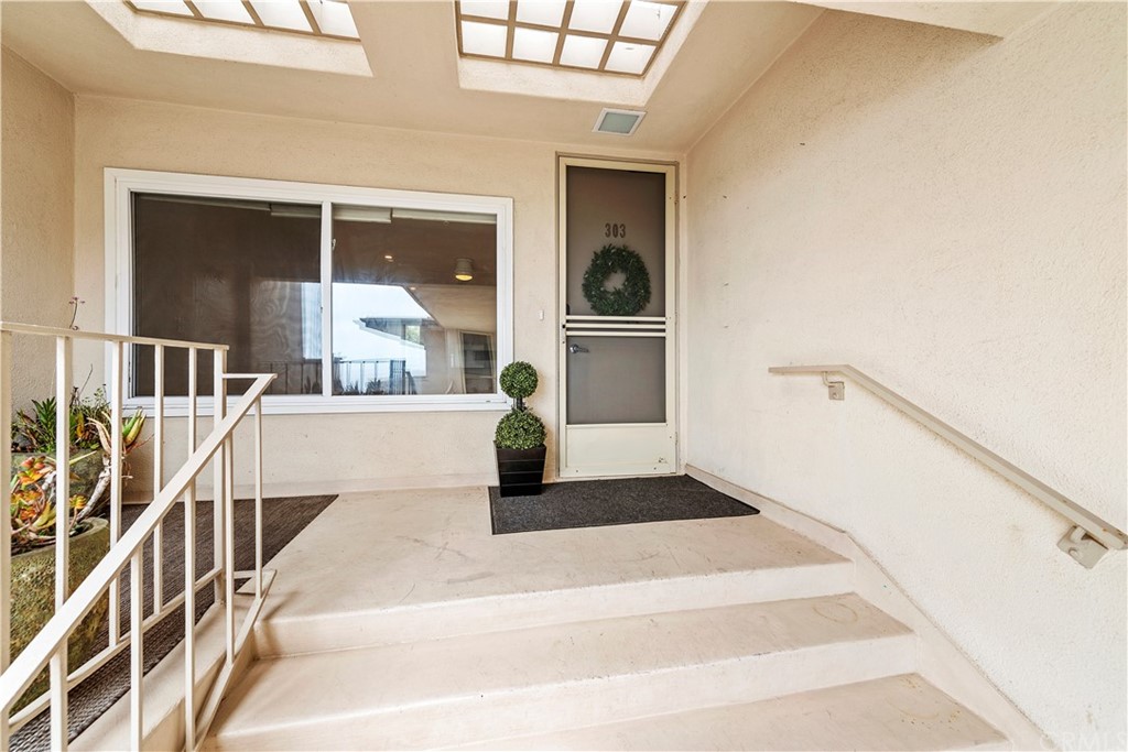 520 Cliff Drive, Unit 303 Laguna Beach, CA 92651 - Photo 4 of 46 a very nice looking room with a large window and chandelier