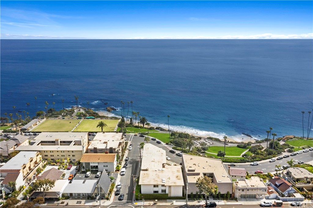 520 Cliff Drive, Unit 303 Laguna Beach, CA 92651 - Photo 43 of 46 an aerial view of a swimming pool with an ocean and beach