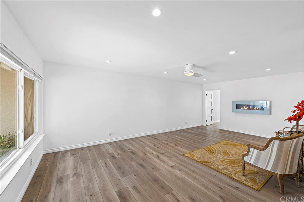 520 Cliff Drive, Unit 303 Laguna Beach, CA 92651 - Photo 5 of 46 an empty room with wooden floor and windows
