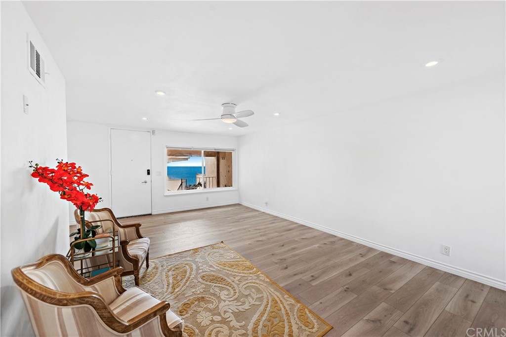 520 Cliff Drive, Unit 303 Laguna Beach, CA 92651 - Photo 9 of 46 a living room with furniture and flowers