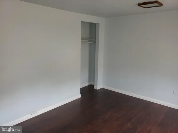 an empty room with wooden floor