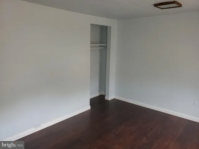 an empty room with wooden floor