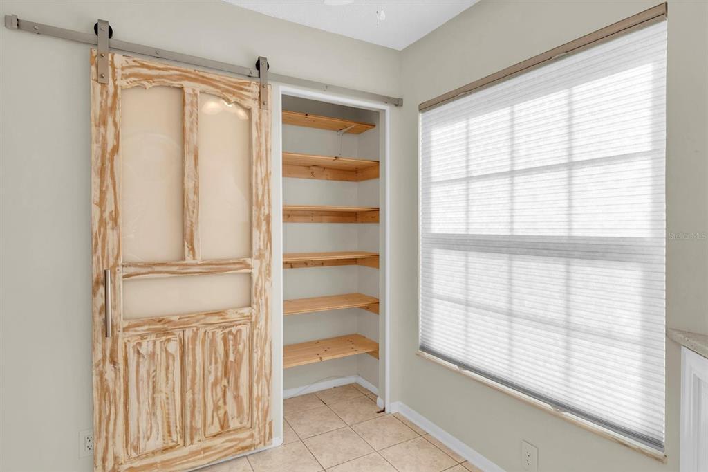 4814 Grist Mill Circle New Port Richey, FL 34655 - Photo 14 of 63 a view of an empty room with a window