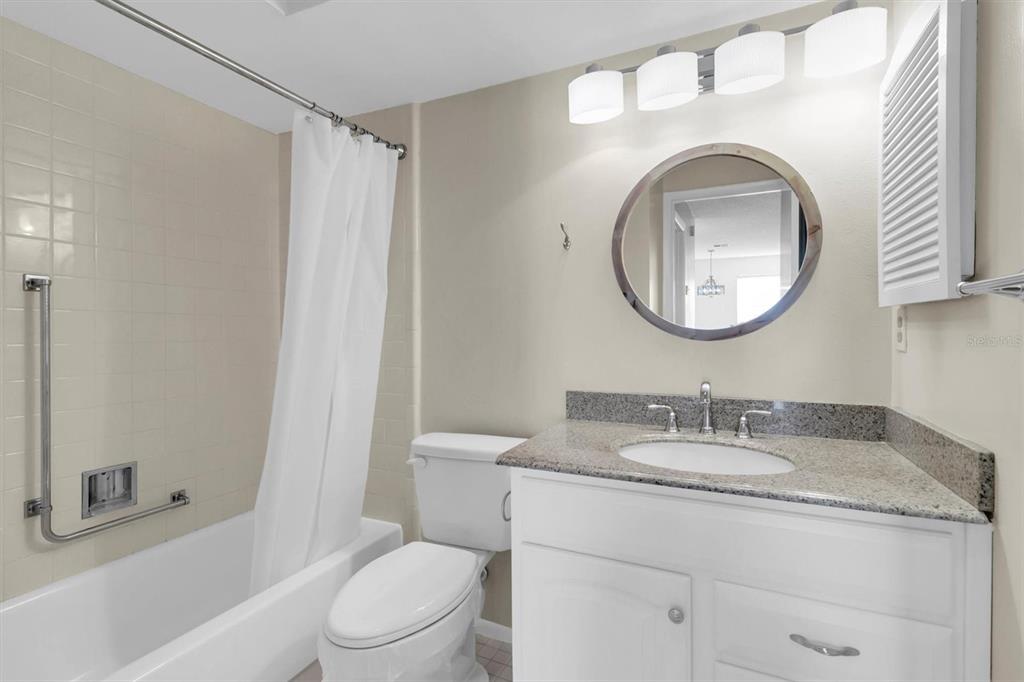 4814 Grist Mill Circle New Port Richey, FL 34655 - Photo 20 of 63 a bathroom with a toilet sink vanity tub and mirror