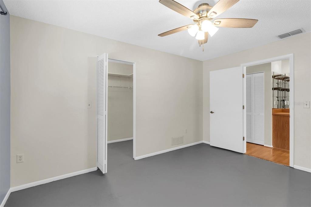4814 Grist Mill Circle New Port Richey, FL 34655 - Photo 23 of 63 an empty room with closet and a chandelier fan