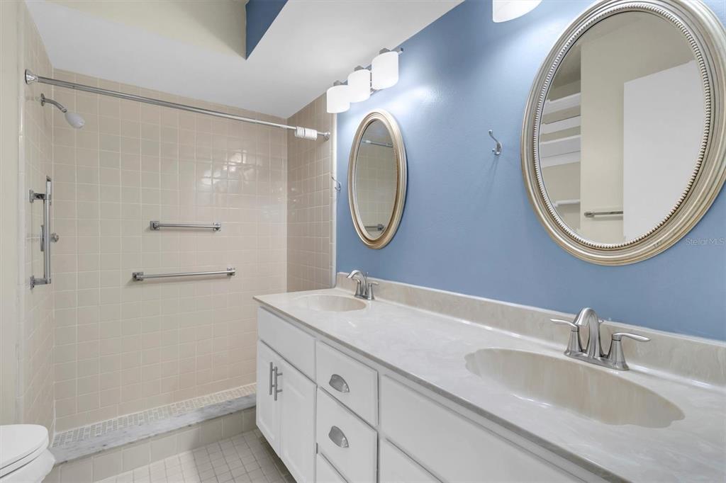 4814 Grist Mill Circle New Port Richey, FL 34655 - Photo 26 of 63 a bathroom with a granite countertop double vanity sink and a mirror