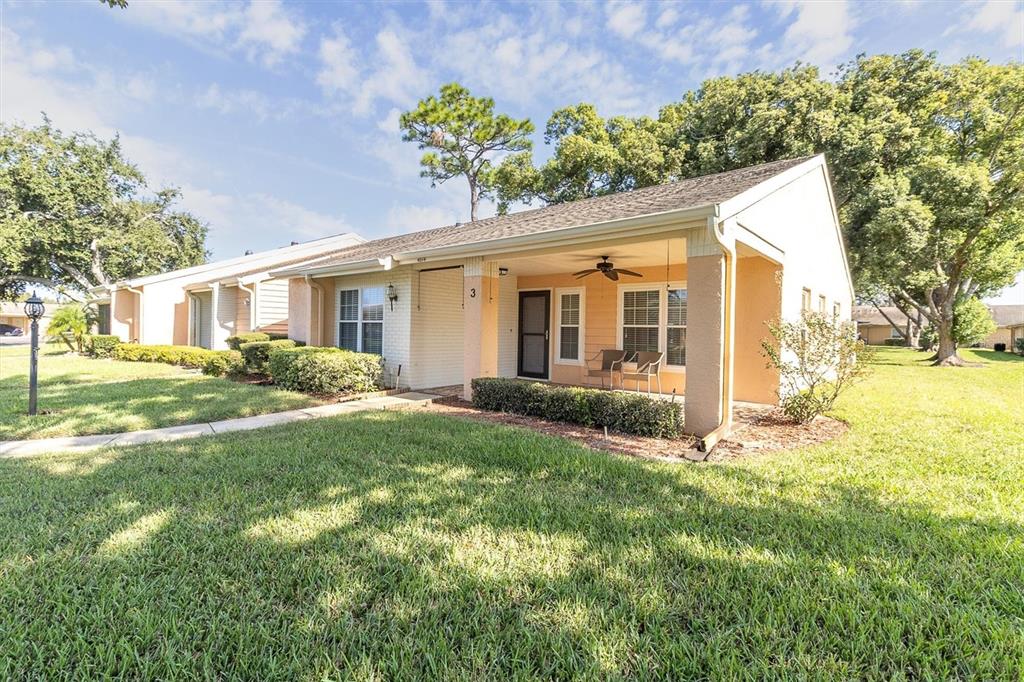 4814 Grist Mill Circle New Port Richey, FL 34655 - Photo 32 of 63 a front view of house with yard and trees around