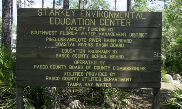 4814 Grist Mill Circle New Port Richey, FL 34655 - Photo 60 of 63 a sign on the side of the building