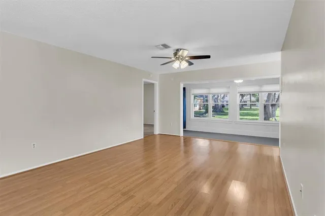 wooden floor in an empty room with a window