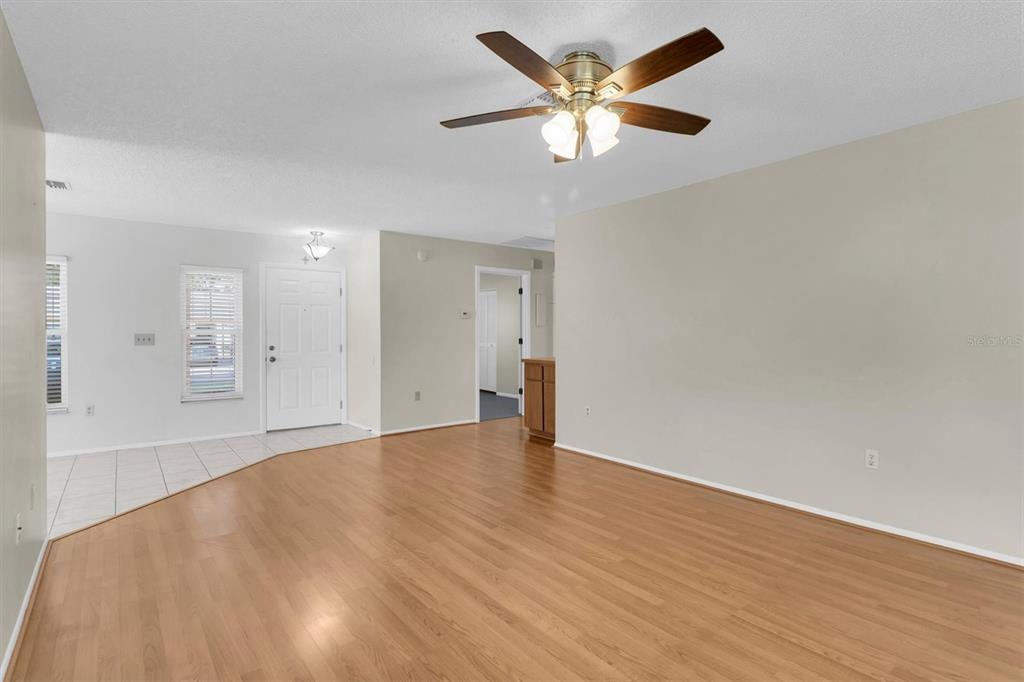 4814 Grist Mill Circle New Port Richey, FL 34655 - Photo 9 of 63 an empty room with wooden floor and windows