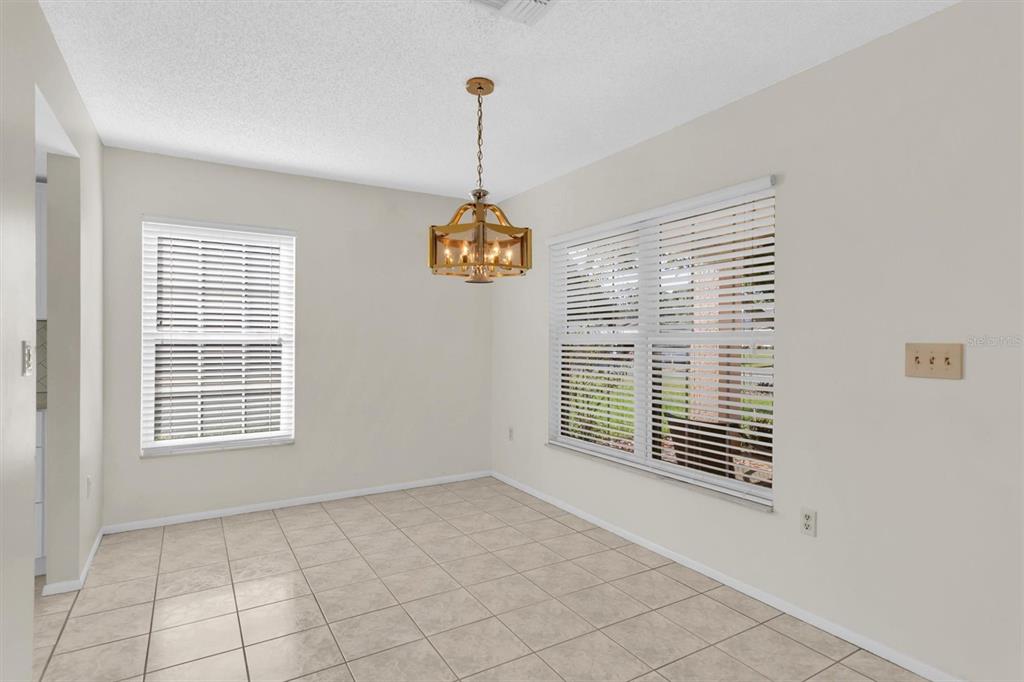 4814 Grist Mill Circle New Port Richey, FL 34655 - Photo 10 of 63 a view of an empty room with a window and chandelier