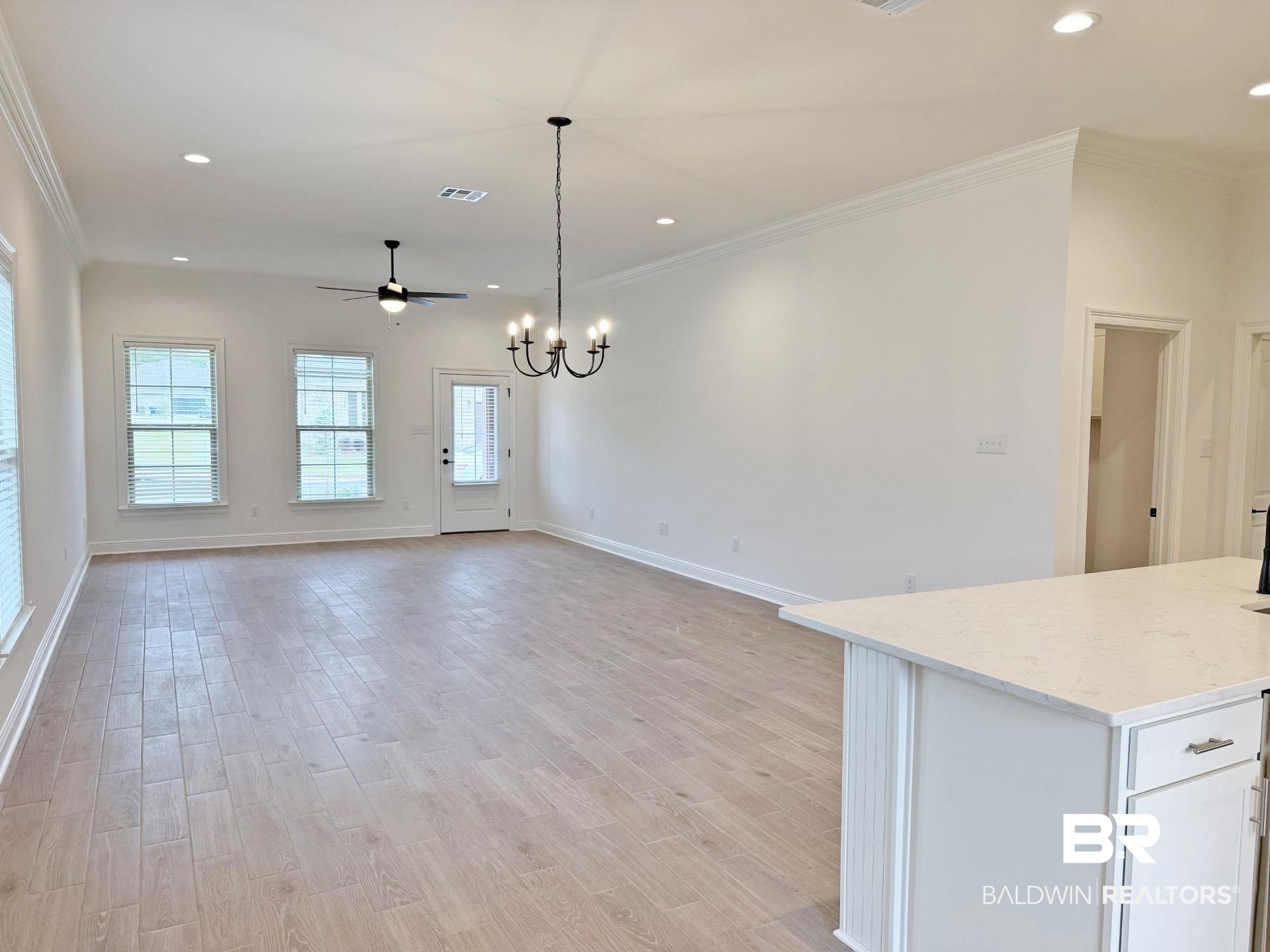 1753 Breckinridge Place Foley, AL 36535 - Photo 7 of 24 Spacious living area featuring light wood-finish flooring, recessed lighting, and crown molding