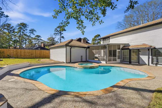 a view of a house with swimming pool and sitting area