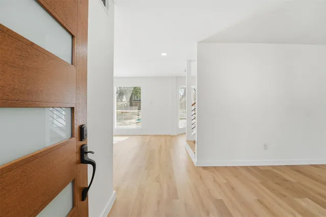 a view of hallway with wooden floor