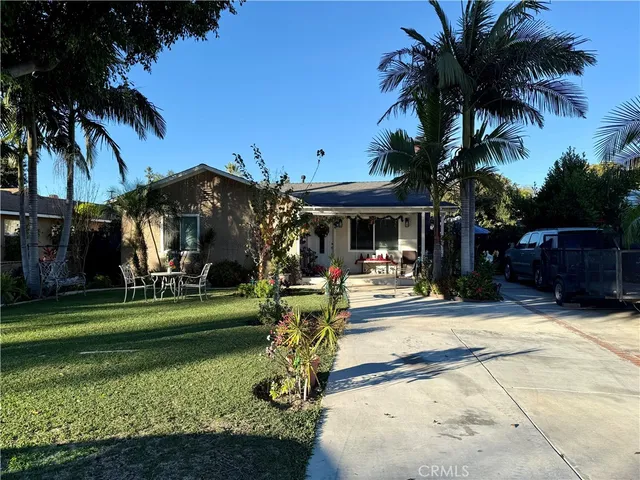 a view of a chair and tables in the patio in front of a house