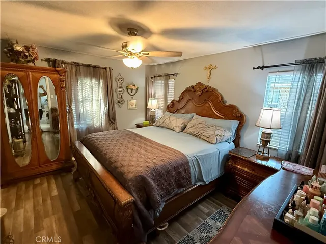 a bedroom with a bed mirror and window