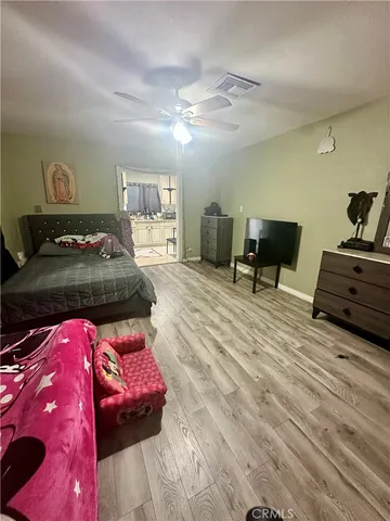 a bedroom with furniture and a chandelier