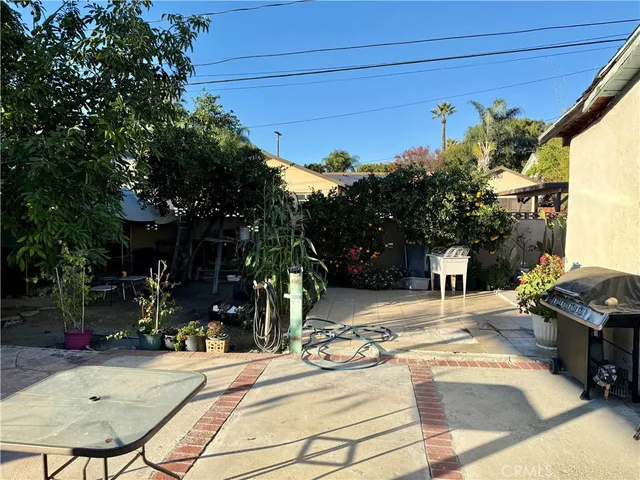 a view of a patio with table and chairs and potted plants