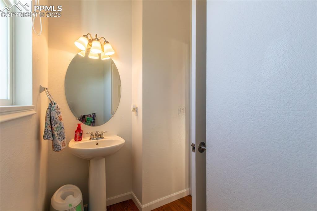 7544 Jaoul Point Peyton, CO 80831 - Photo 12 of 37 a bathroom with a sink and a mirror
