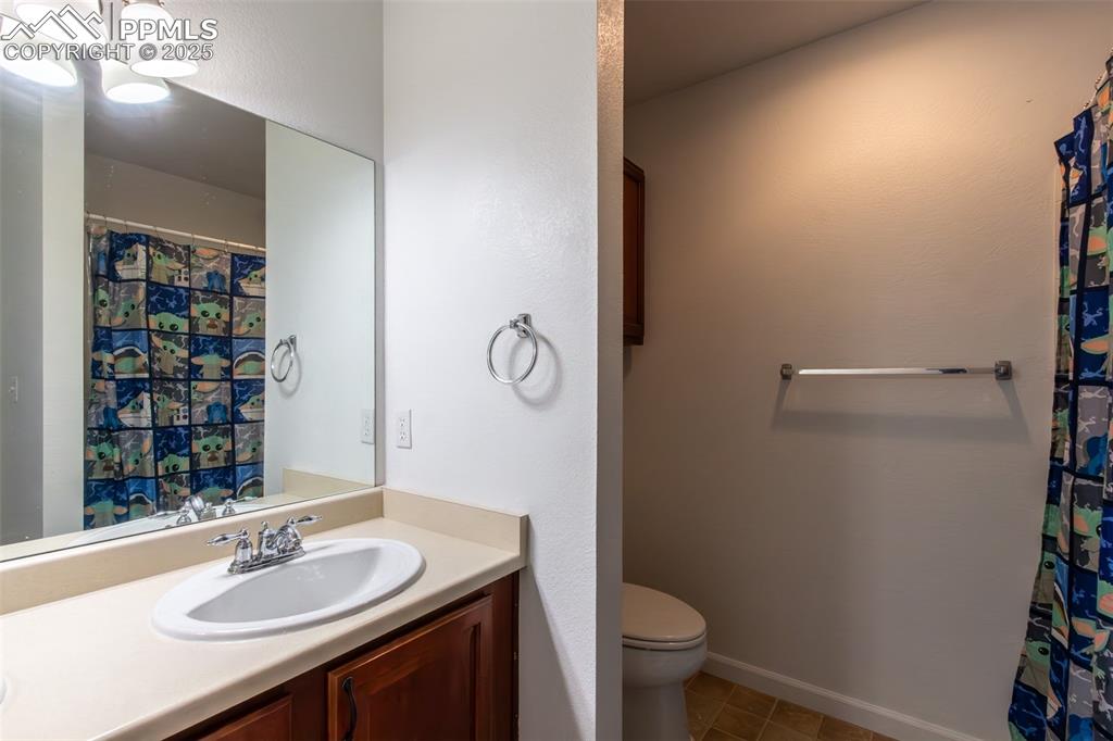 7544 Jaoul Point Peyton, CO 80831 - Photo 25 of 37 a bathroom with a sink a toilet and shower