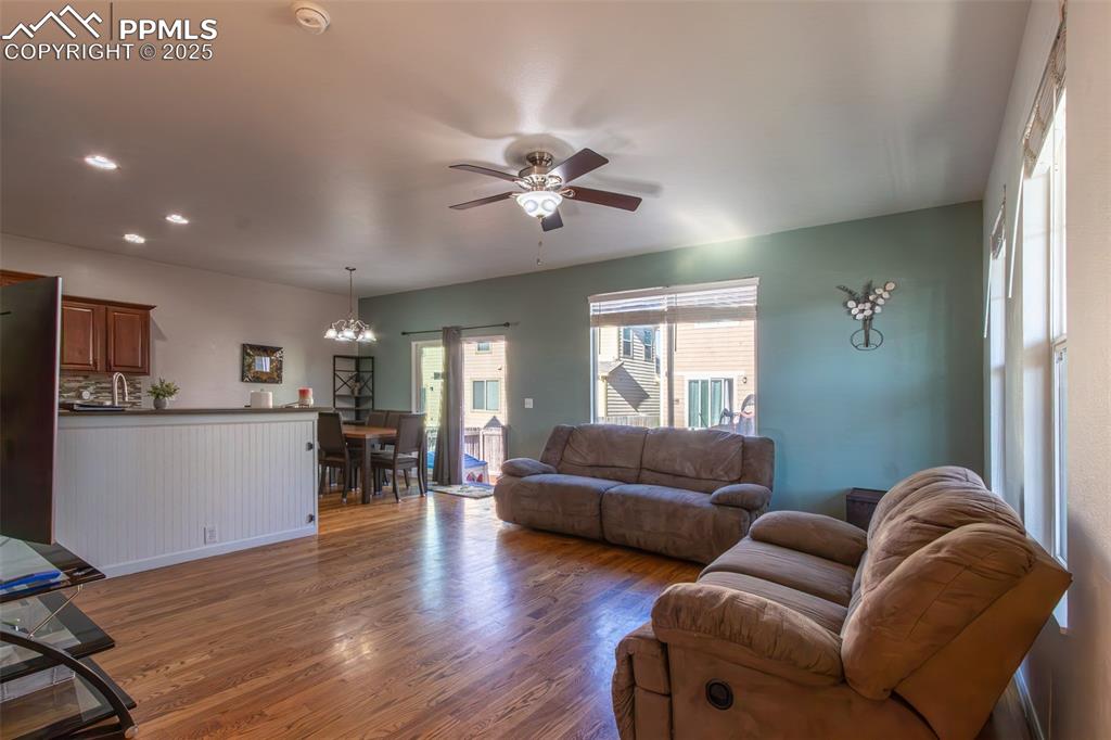 7544 Jaoul Point Peyton, CO 80831 - Photo 5 of 37 a living room with furniture ceiling fan and a window