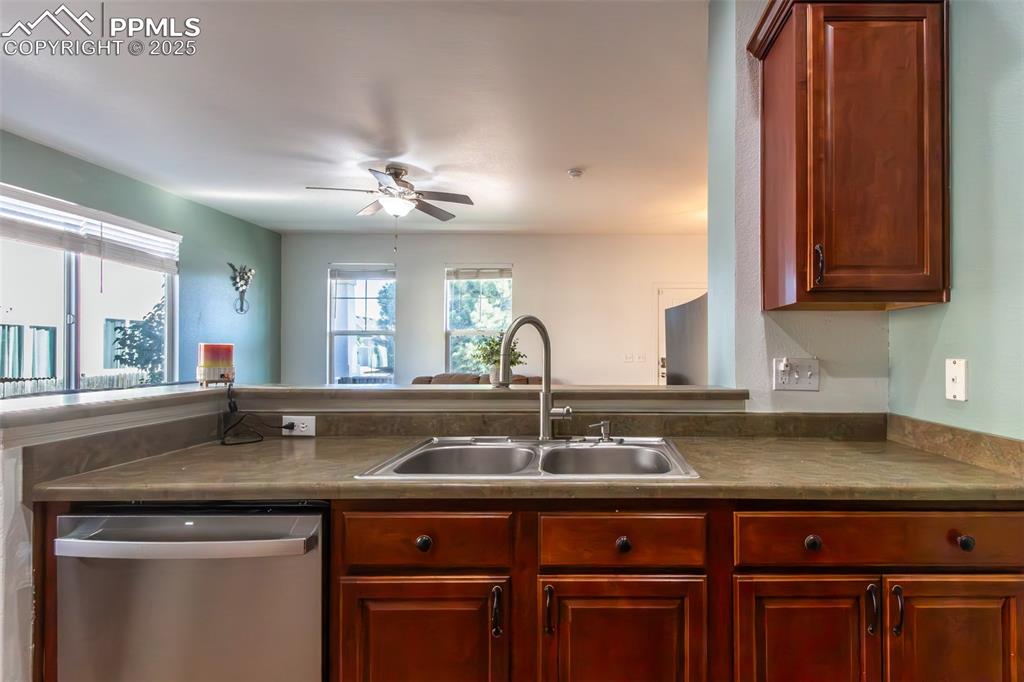 7544 Jaoul Point Peyton, CO 80831 - Photo 9 of 37 a kitchen with granite countertop a sink and cabinets