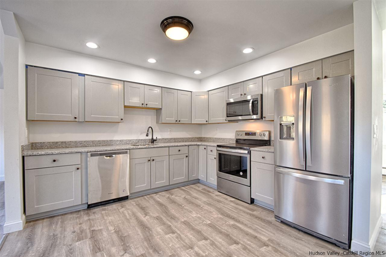 2386 Bruynswick Road Wallkill, NY 12589 - Photo 8 of 25 a kitchen with granite countertop stainless steel appliances and wooden cabinets