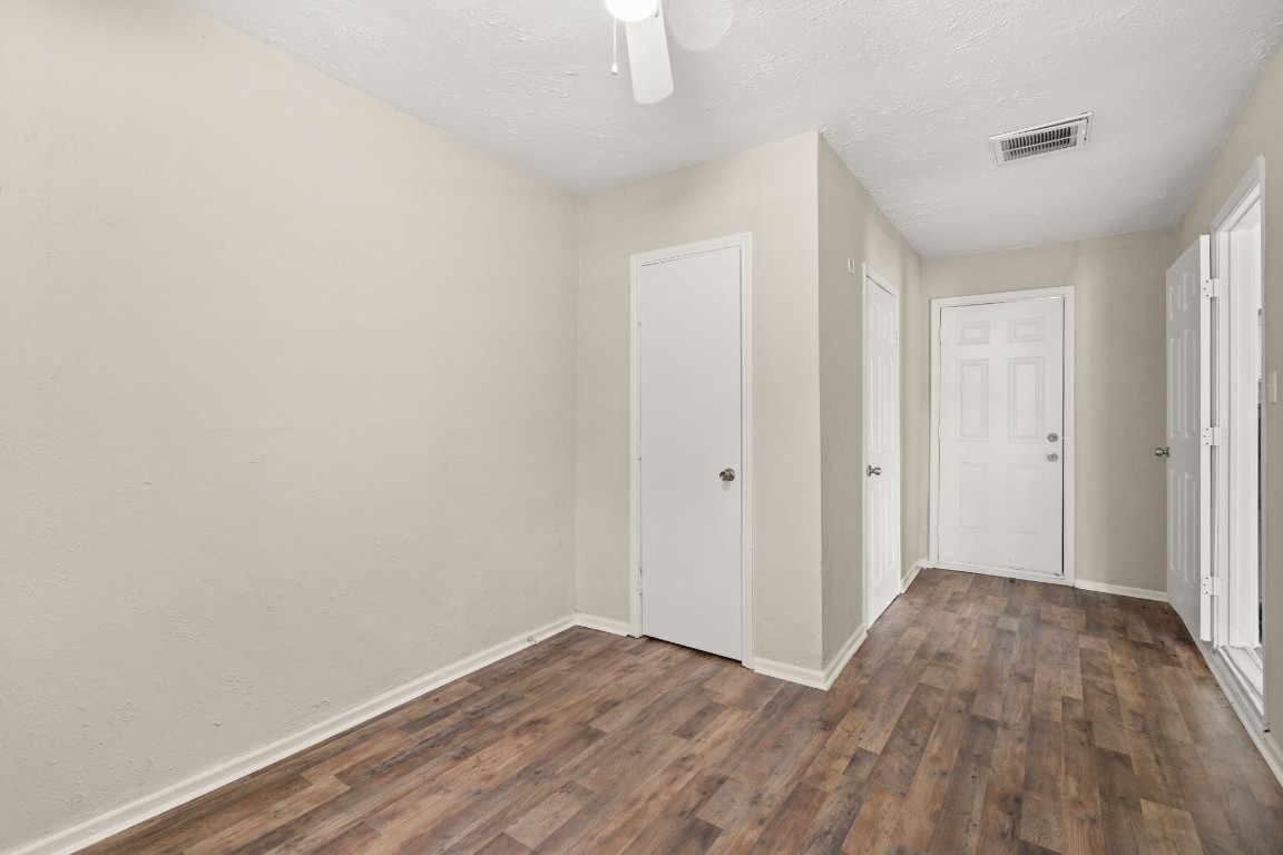 3031 Friar Point Road Houston, TX 77051 - Photo 11 of 15 Fourth bedroom features laminate floors, custom paint, white stained ceiling fan with lighting and window to let in natural lighting, and a door with direct access to the front of your home.