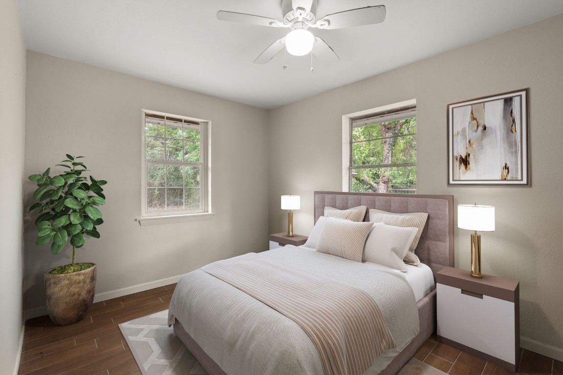 3031 Friar Point Road Houston, TX 77051 - Photo 6 of 15 The primary bedroom offers abundant natural light with two large windows, a ceiling fan for added comfort, and sleek tile flooring that adds a modern touch to the space. *Virtually Staged*