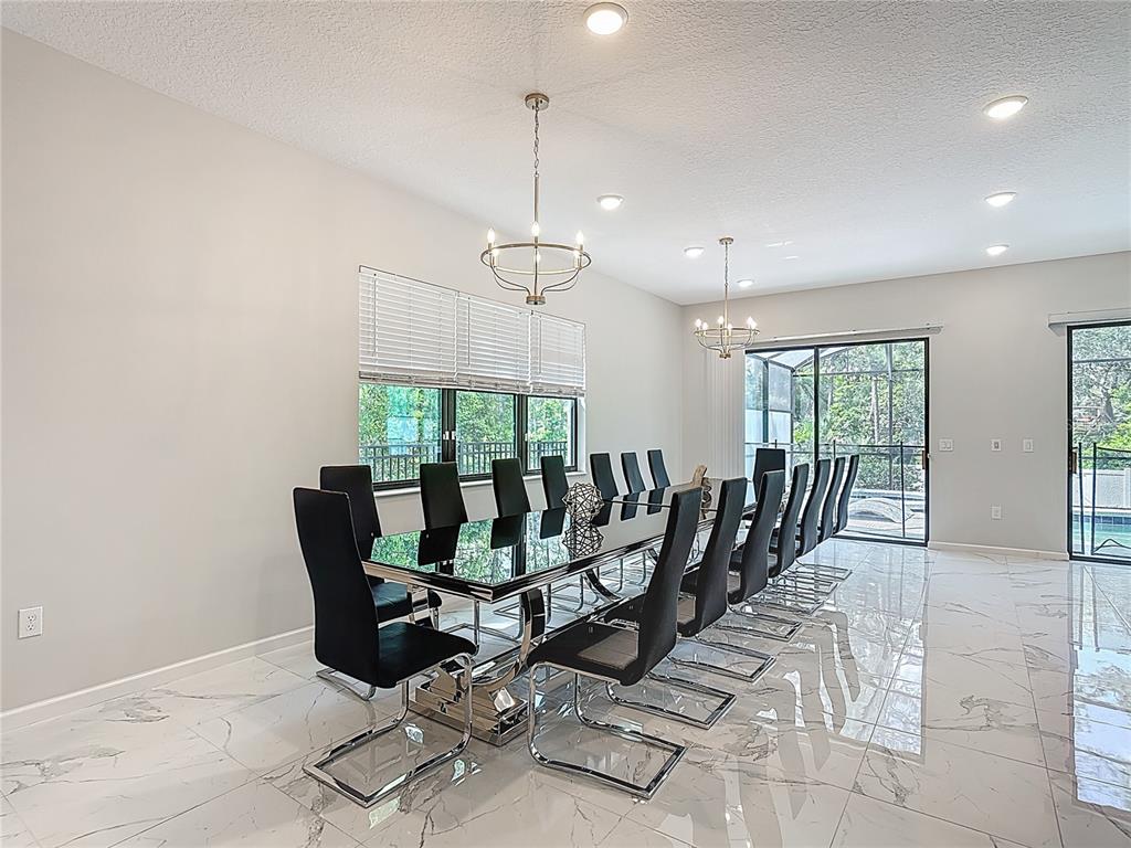 1326 Butterfly Orchid Road Davenport, FL 33837 - Photo 17 of 54 a view of a dining room with furniture window and outside view