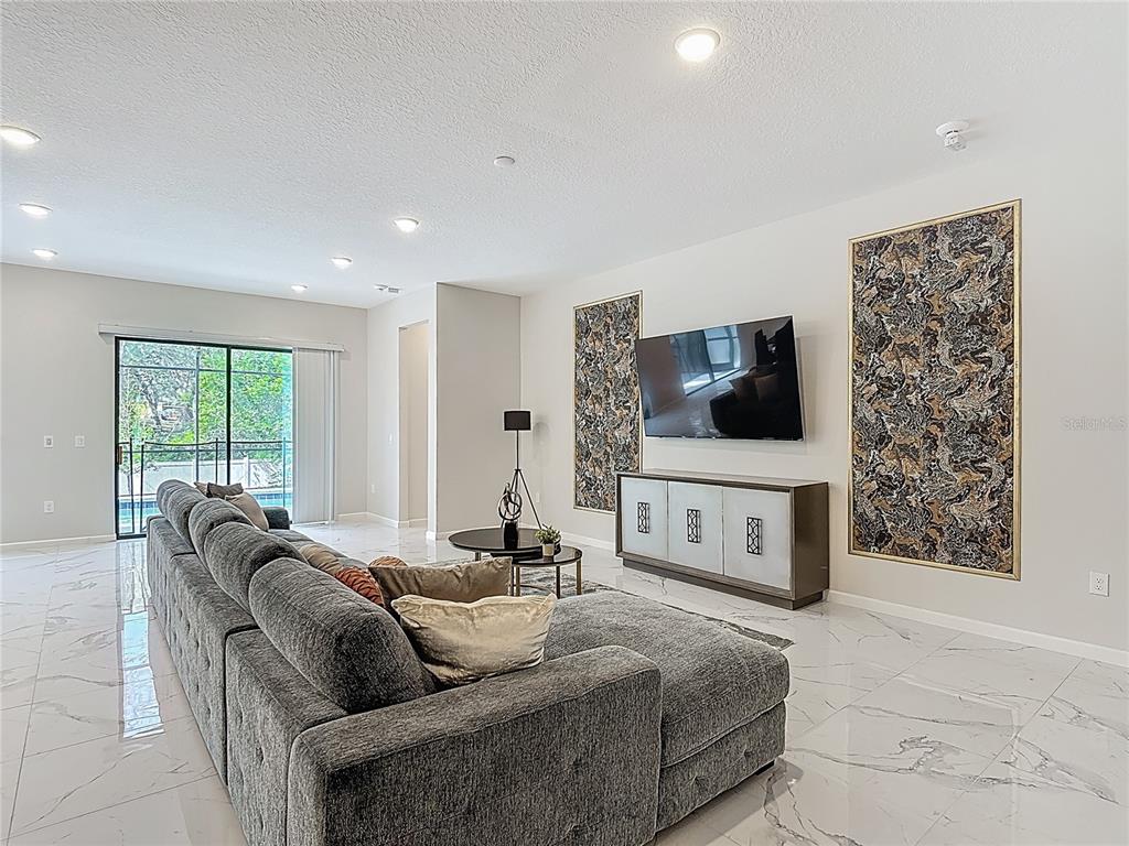 1326 Butterfly Orchid Road Davenport, FL 33837 - Photo 20 of 54 a living room with furniture and a flat screen tv