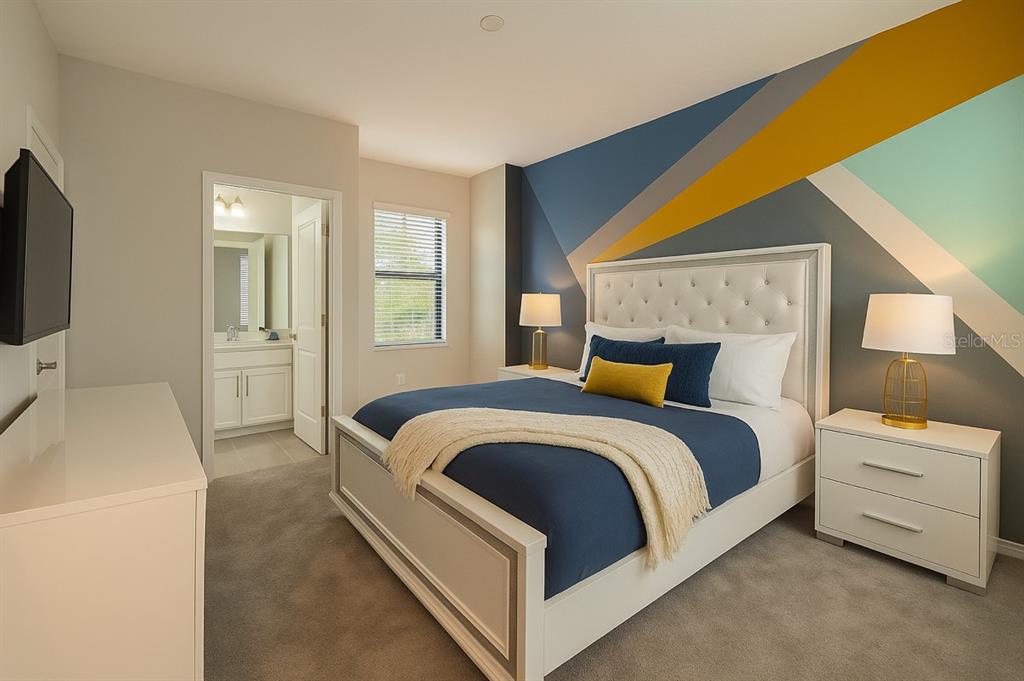 1326 Butterfly Orchid Road Davenport, FL 33837 - Photo 23 of 54 a bedroom with a bed and a flat tv screen