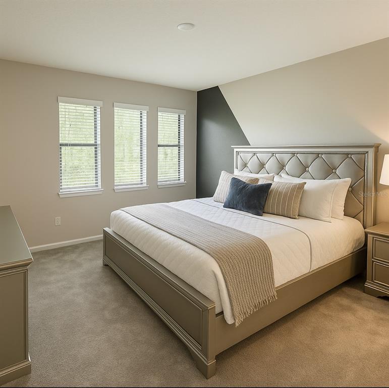 1326 Butterfly Orchid Road Davenport, FL 33837 - Photo 27 of 54 a large bed sitting in a bedroom next to a window