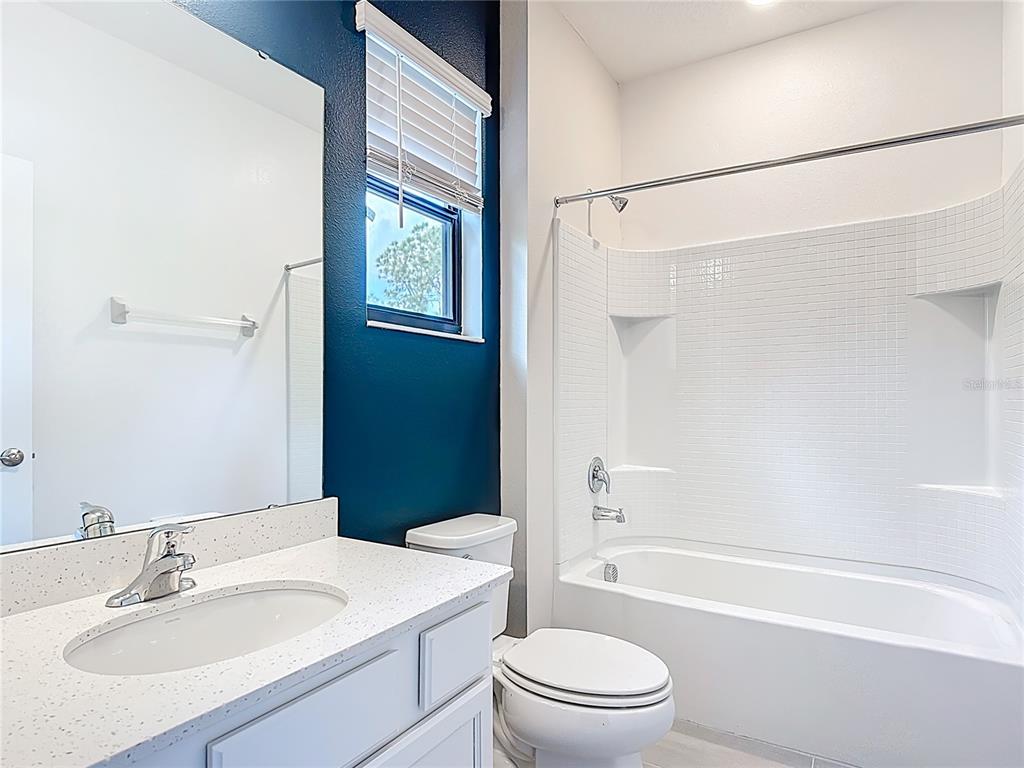 1326 Butterfly Orchid Road Davenport, FL 33837 - Photo 35 of 54 a bathroom with a sink toilet and shower