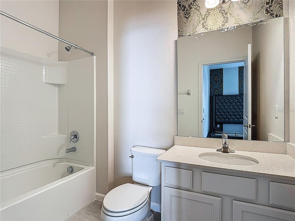 1326 Butterfly Orchid Road Davenport, FL 33837 - Photo 41 of 54 a bathroom with a sink a toilet and shower